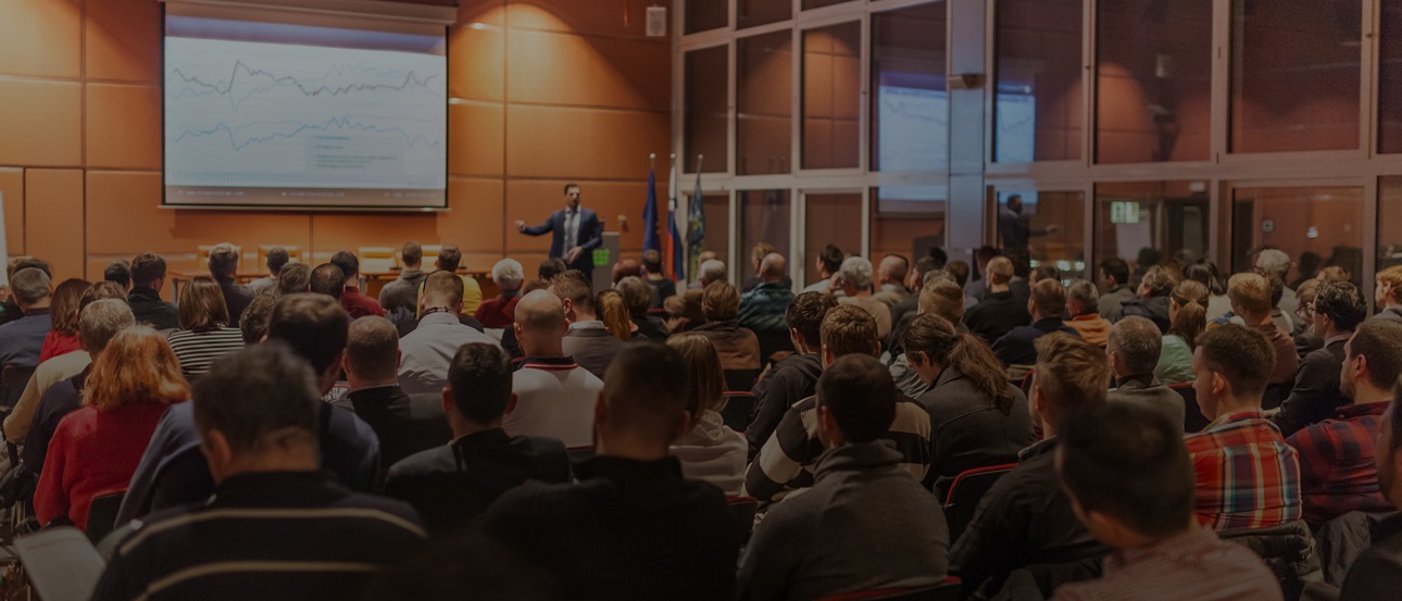 A meeting session in a large auditorium