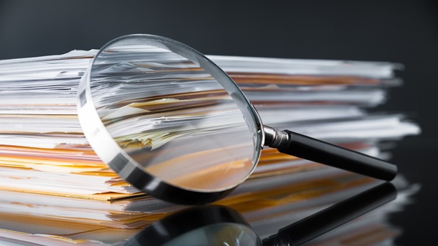 Magnifying glass in front of documents